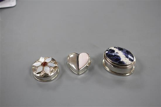 Three assorted modern silver pill boxes, including oval with hardstone lid, heart shaped and circular with shell inset lid, largest 4cm